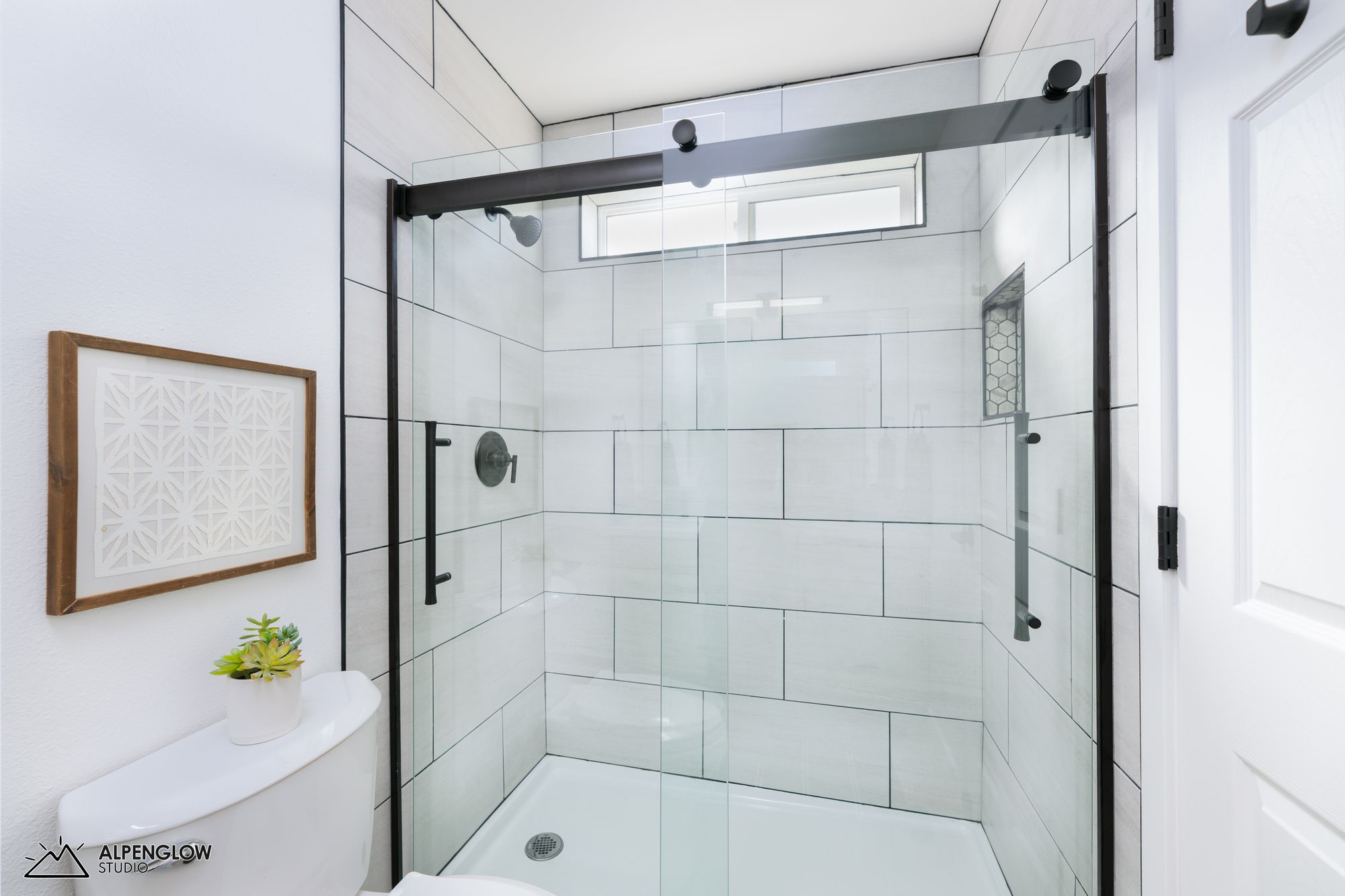Walk-in shower with large format tile and glass enclosure